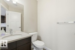 Half bathroom featuring vanity and toilet - 