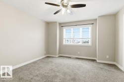 Unfurnished room featuring light colored carpet and a ceiling fan - 