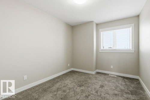 Unfurnished room with carpet flooring and baseboards - 2 Wingate Way, Fort Saskatchewan, AB - Indoor Photo Showing Other Room