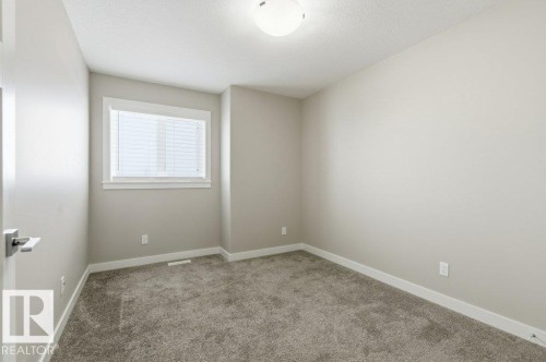 Empty room with light carpet and a textured ceiling - 2 Wingate Way, Fort Saskatchewan, AB - Indoor Photo Showing Other Room