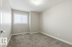 Empty room with light carpet and a textured ceiling - 