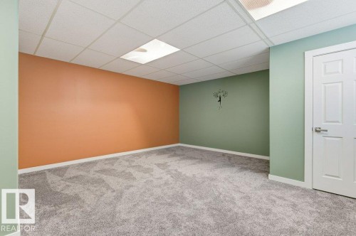 Carpeted empty room with a paneled ceiling and baseboards - 2 Wingate Way, Fort Saskatchewan, AB - Indoor