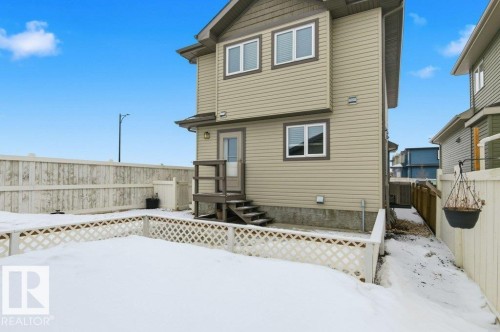 Snow covered back of property with a fenced backyard - 2 Wingate Way, Fort Saskatchewan, AB - Outdoor With Exterior