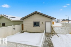 Snow covered back of property with a fenced backyard - 
