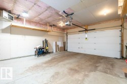 Garage featuring a heating unit and a garage door opener - 
