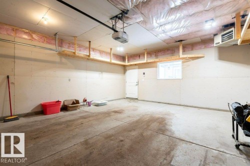 Garage featuring a heating unit and a garage door opener - 2 Wingate Way, Fort Saskatchewan, AB - Indoor Photo Showing Garage