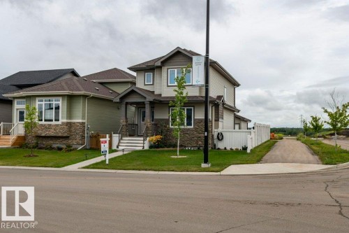 Craftsman house featuring stone siding and a front lawn - 2 Wingate Way, Fort Saskatchewan, AB - Outdoor With Facade
