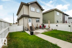 Back of house with a fenced backyard and entry steps - 