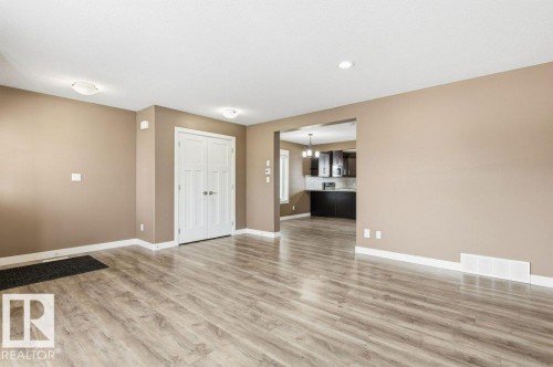Unfurnished living room with light wood finished floors, a chandelier, and recessed lighting - 2 Wingate Way, Fort Saskatchewan, AB - Indoor Photo Showing Other Room