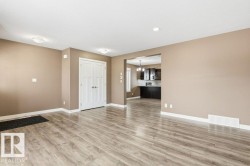 Unfurnished living room with light wood finished floors, a chandelier, and recessed lighting - 