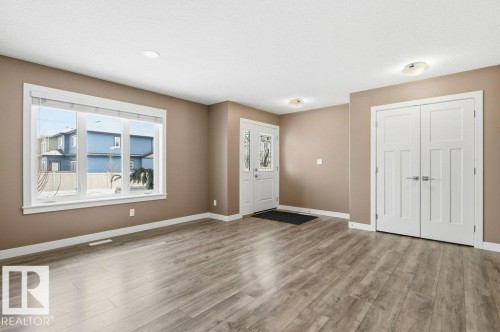 Foyer featuring baseboards and light wood-style flooring - 2 Wingate Way, Fort Saskatchewan, AB - Indoor Photo Showing Other Room