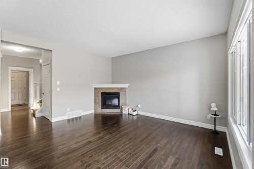 3683 8 Street, Edmonton, AB - Indoor Photo Showing Living Room With Fireplace