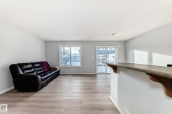 Living room with baseboards and light wood-style flooring - 