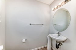 Half bathroom with toilet and wood finished floors - 