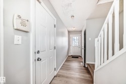 Doorway to outside with wood finished floors and a textured ceiling - 