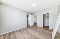 Unfurnished bedroom with light wood-style flooring, a closet, and a textured ceiling - 