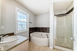 Bathroom with vanity, a shower stall, a bath, and a textured ceiling - 