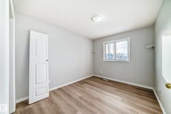 Empty room featuring light wood finished floors and baseboards - 