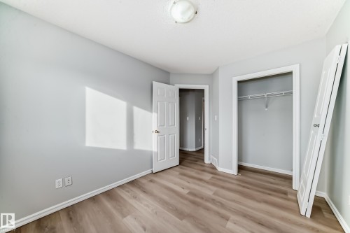 Unfurnished bedroom with light wood-style floors and a closet - 7731 8 Avenue, Edmonton, AB - Indoor Photo Showing Other Room
