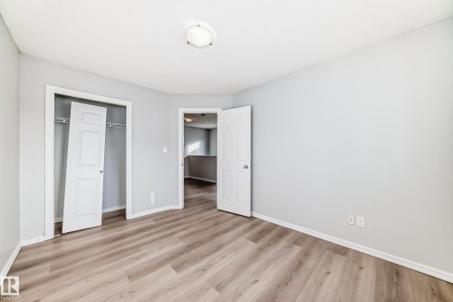 Unfurnished bedroom featuring light wood-type flooring and a closet - 7731 8 Avenue, Edmonton, AB - Indoor Photo Showing Other Room