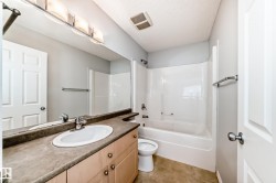 Bathroom featuring vanity, shower / washtub combination, and a textured ceiling - 