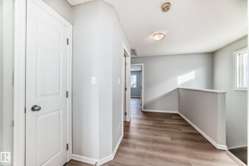 Corridor with an upstairs landing and light wood-style floors - 7731 8 Avenue, Edmonton, AB - Indoor Photo Showing Other Room