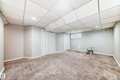 Finished basement featuring a drop ceiling, carpet floors, and recessed lighting - 7731 8 Avenue, Edmonton, AB - Indoor