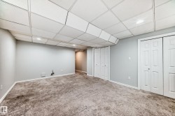 Finished below grade area with a drop ceiling, carpet floors, and recessed lighting - 