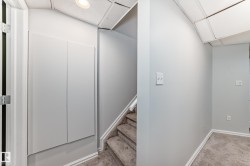 Stairway with carpet flooring and a drop ceiling - 