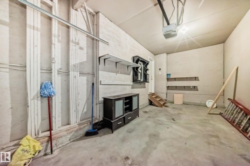 Garage featuring a garage door opener - 7731 8 Avenue, Edmonton, AB - Indoor Photo Showing Other Room