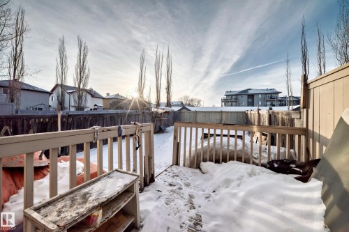 Snow covered deck with a residential view and a fenced backyard - 7731 8 Avenue, Edmonton, AB - Outdoor