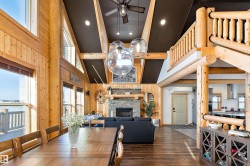 Dining area featuring recessed lighting, dark wood finished floors, a fireplace, wood walls, and ceiling fan - 