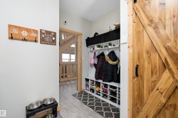 Mudroom with a barn door and tile patterned floors - 