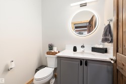 Half bathroom featuring vanity and toilet - 
