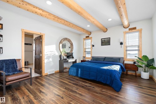 Bedroom featuring beam ceiling, wood finished floors, and recessed lighting - 19003 Twp Rd 522, Rural Beaver County, AB - Indoor Photo Showing Bedroom