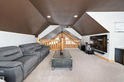 Living room featuring lofted ceiling, a textured ceiling, light colored carpet, and recessed lighting - 