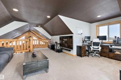 Office area with a textured ceiling, light carpet, vaulted ceiling, and recessed lighting - 