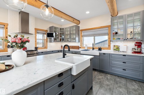 Kitchen featuring gray cabinets, decorative backsplash, wall chimney exhaust hood, recessed lighting, and beam ceiling - 19003 Twp Rd 522, Rural Beaver County, AB - Indoor Photo Showing Kitchen