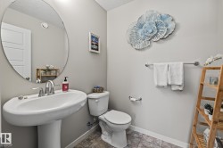 Half bathroom with toilet and a textured ceiling - 