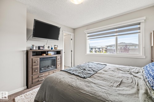 Bedroom featuring carpet flooring and a textured ceiling - 20110 27 Avenue, Edmonton, AB - Indoor Photo Showing Bedroom