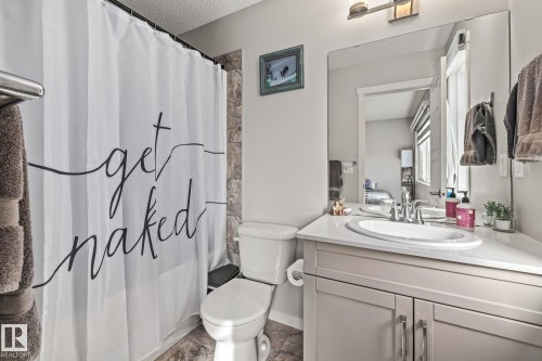 Bathroom with vanity and a textured ceiling - 20110 27 Avenue, Edmonton, AB - Indoor Photo Showing Bathroom
