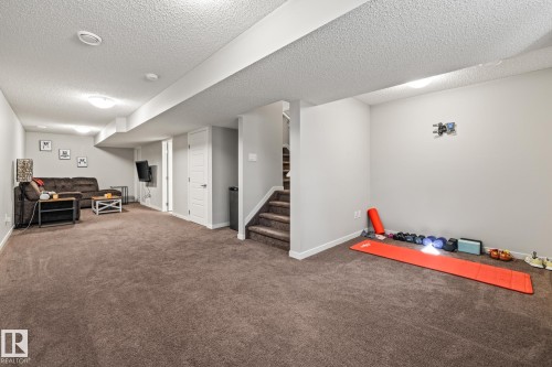 Exercise area with carpet floors and a textured ceiling - 20110 27 Avenue, Edmonton, AB - Indoor Photo Showing Other Room