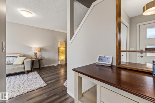 Foyer featuring a textured ceiling and dark wood-style flooring - 20110 27 Avenue, Edmonton, AB - Indoor
