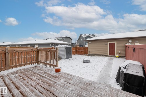 Snow covered deck with a storage shed, a fenced backyard, and an outdoor fire pit - 20110 27 Avenue, Edmonton, AB - Outdoor With Deck Patio Veranda With Exterior