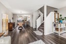 Living area featuring stairs, dark wood-style floors, and a textured ceiling - 20110 27 Avenue, Edmonton, AB  - Indoor 