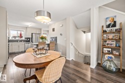 Dining room with dark wood-type flooring and a textured ceiling - 