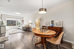 Dining area with a textured ceiling and dark wood finished floors - 