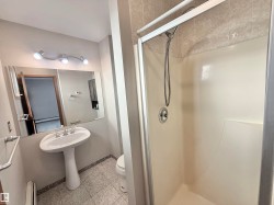 Bathroom with a shower stall and a baseboard radiator - 