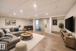 Living area with wood finished floors, a drop ceiling, and recessed lighting - 