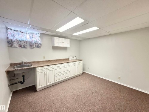 Finished below grade area featuring light carpet and a paneled ceiling - 2112 104B Street, Edmonton, AB - Indoor Photo Showing Basement